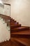 Travertine house- Closeup of wooden, glass stairs