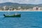 Trawler fishing boat surrounded by seagulls returning to port