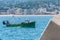 Trawler fishing boat surrounded by seagulls returning to port