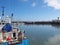 trawler and leisure boats moored in Scarborough harbour and marina in summer sunlight