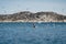 Trawler returning to port and seagulls that accompany him. Small fishing boat in Greenland with mountains and ocean.