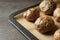 Tray with baked jacket potatoes on table, closeup.