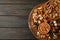 Tray with bowls with different nuts on wooden background