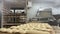 Tray of bread dough cut and ready to bake in the oven and in the background baker spreading the dough on the table create bread.