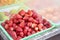 Tray of chilled strawberries on counter of fruit shop