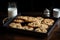 tray of classic chocolate chip cookies, with glass of milk on the side