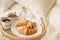 Tray with coffee cup, croissants, muesli and white flowers