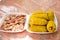 A tray is filled with corn and shrimp. Picnic outdoor