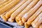 Tray of fresh baked mexican churros covered in sugar