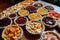 tray of fruit pies and tarts, ready to be baked