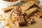 Tray with granola bars and bowl with almond on wooden background