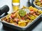 Tray of loaded mexican nachos with beef and queso cheese