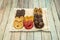 Tray of mini chocolate palm trees of various flavors on wooden table