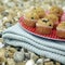 A tray of muffins on a folded picnic blanket. Conceptual image