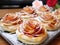 A tray of pastries with roses on top of it, Valentine's day desserts.