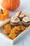 A tray of pumpkin spice cookies and cupcakes ready for snacking.