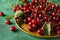 Tray with ripe cherries on color textured background