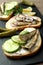 Tray with sandwiches with sprats, close up and selective focus