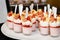 A tray of strawberry parfait desserts ready to be served.