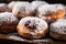 A tray of sufganiyot, a Hanukkah treat filled with jelly and dusted with powdered sugar