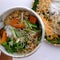 Tray of vegetarian food ready to eat, vegan noodles mixing with vegetables, simple homemade food