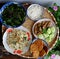 Tray of Vietnamese vegetarian meal for lunch time, leaf mustard soup, fried cabbage, vegan meat