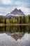 Tre Cime di Lavaredo peaks and Lake Antorno with sky reflection in calm water. Dolomites Alp Mountains, Belluno Province, Dolomiti