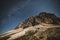 Tre Cime Dolomiti and night sky with galaxy