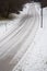 A treacherous looking road covered with snow