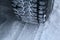 Tread area of winter tire packed with the snow close up