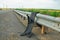 Tread from a truck tire hanging over a guard rail.