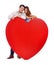 Treasuring every moment together. Studio shot of a loving couple standing behind a large heart isolated on white.