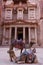 Treasury ancient architecture with camels in valley in Petra, Jordan