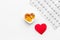 Treat heart. Pills in bowl in shape of heart and cardiogram on white background top view copyspace