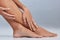 Treat yourself to a pedicure. Cropped shot of an unrecognizable woman sitting alone and touching her legs in the studio.