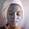 Treating herself to a luxurious facial treatment. a young woman enjoying a facial treatment at a spa.