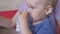 Treatment of lung disease with an inhaler. A little boy in the mask of an inhaler. Treatment at home.