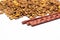 Treats for cats meat sticks sausages against the background of dry food. Complete diet for adult cats