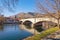 Trebisnjica river near Old Town of Trebinje on sunny winter day. Stone bridge over river Trebisnjica. Bosnia and Herzegovina