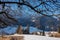 Tree branch with scenic view on hiking village Zell Pfarre (Sele), Austrian Alps, Carinthia (Kaernten), Austria, Europe