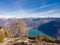 The tree on the cliff over the lake Santa Croce and the Dolomites Alps