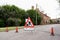 Tree cutting safety sign and orange cones blocking off road to keep the general public safely away from the danger zone from