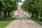 Tree lined driveway to mansion