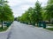 Tree lined urban street with dustbins ready