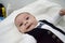 Tree months old newborn baby boy dressed like businessman with bow tie, face expresion