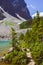 A tree and the path around the shores of Lake Annette in Banff National Park