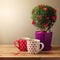 Tree plant with heart shapes and cups of tea for Valentine\'s day celebration