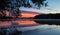 Tree silhouetted against a colorful sunrise