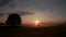 A tree is silhouetted against a sunrise near the Village of Esholt, Malham ,