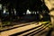 Tree silhouettes on a sand walk path in a dark park